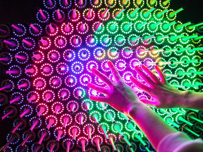 Human hands on colourful spokes 