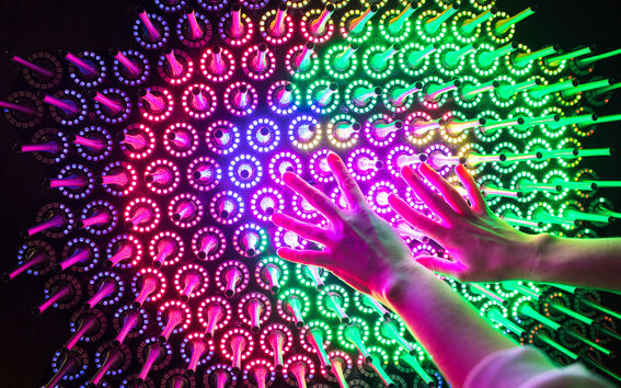 Human hands on colourful spokes 